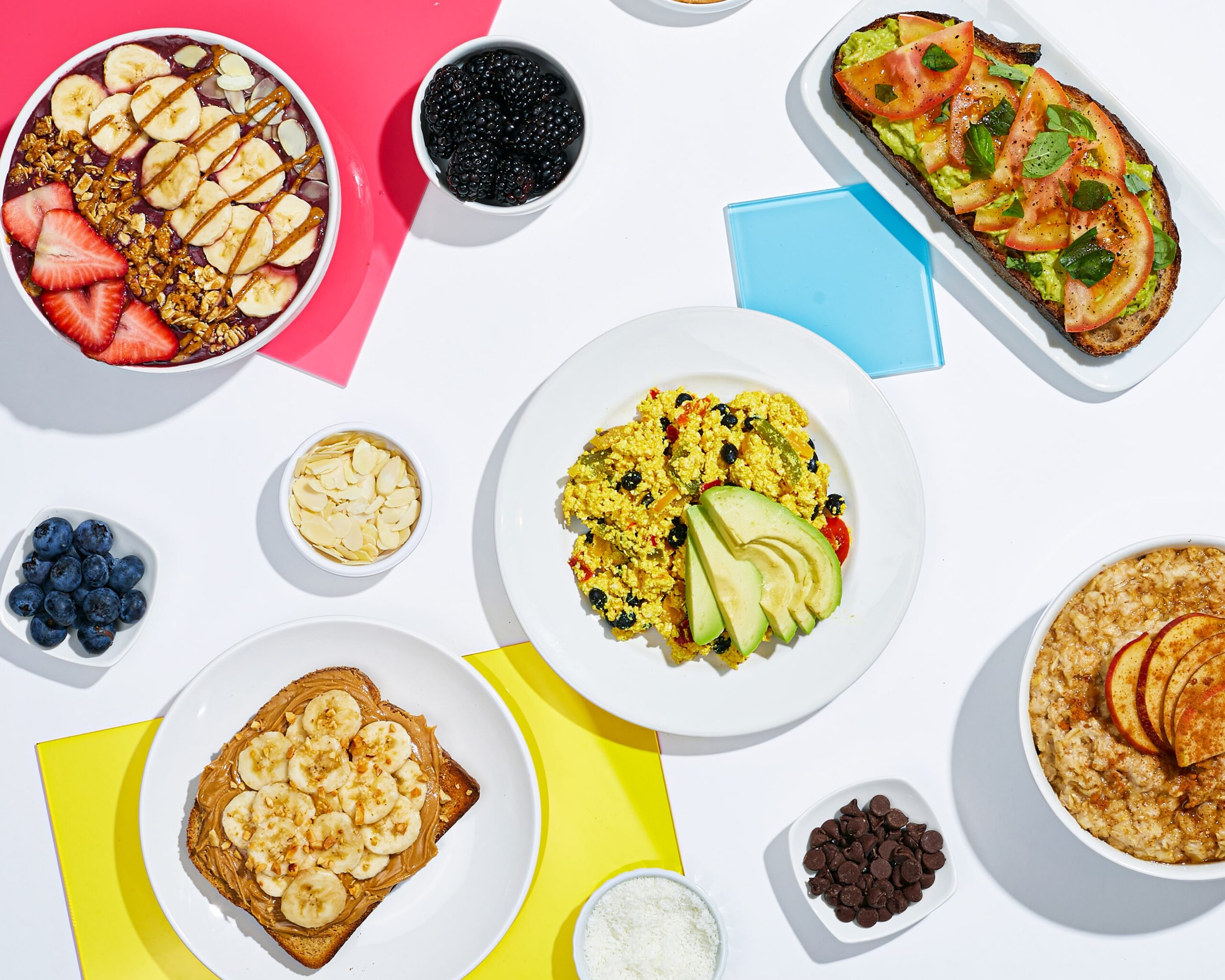 Vegan Breakfast Spread Featuring Peanut Butter Toast, Avocado Toast, Oatmeal and Granola